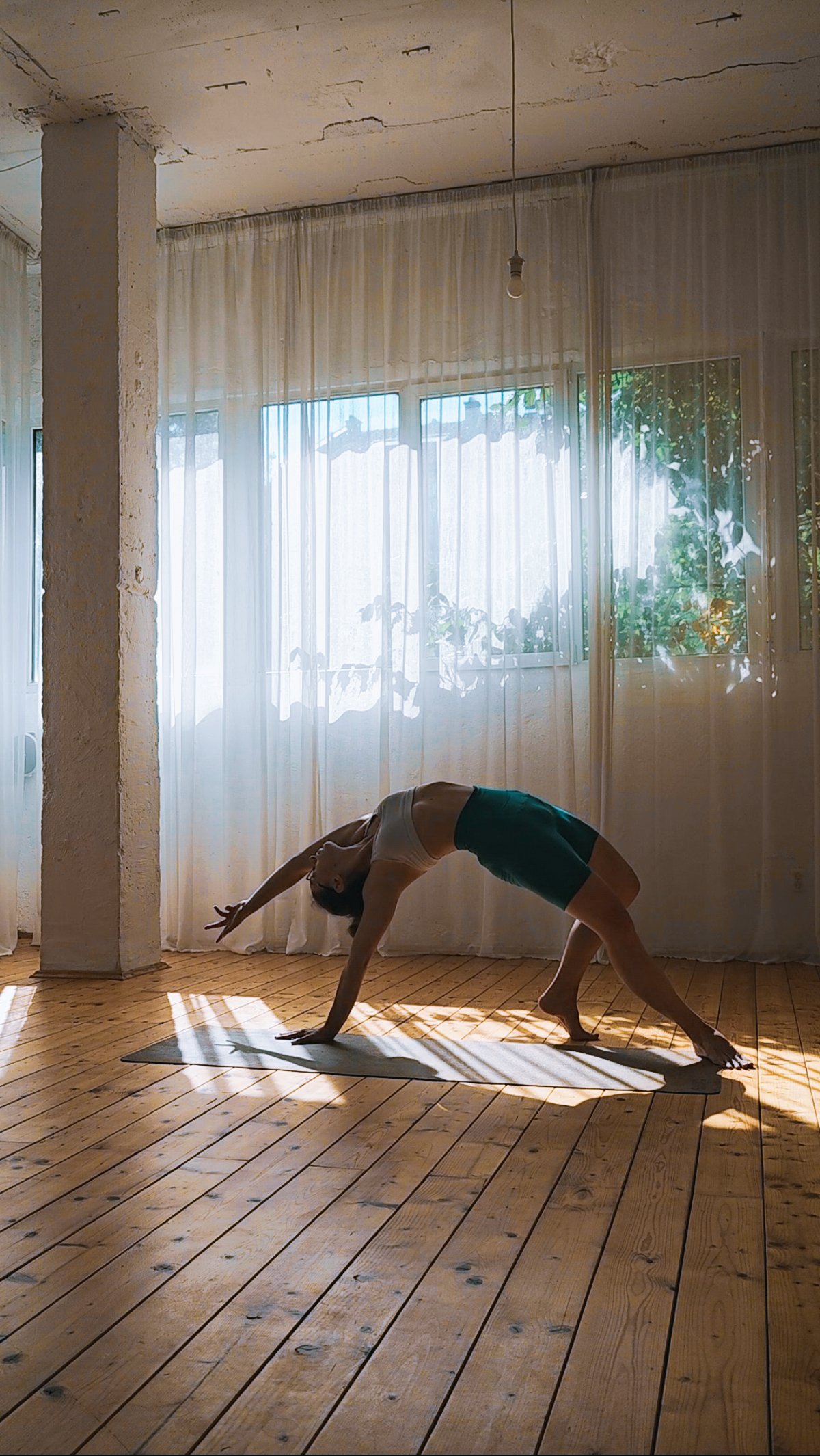 Wild thing pose in yoga with contre-jour light